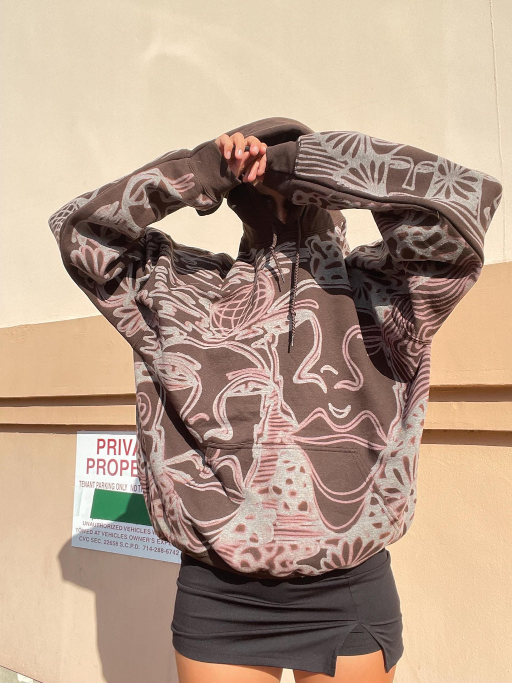 .Abstract faces, spotted mushroom clouds, and geometric cozy hoodie in dark chocolate brown and cream