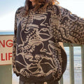 Abstract faces and geometric style spotted and striped groovy hoodie in black and grey