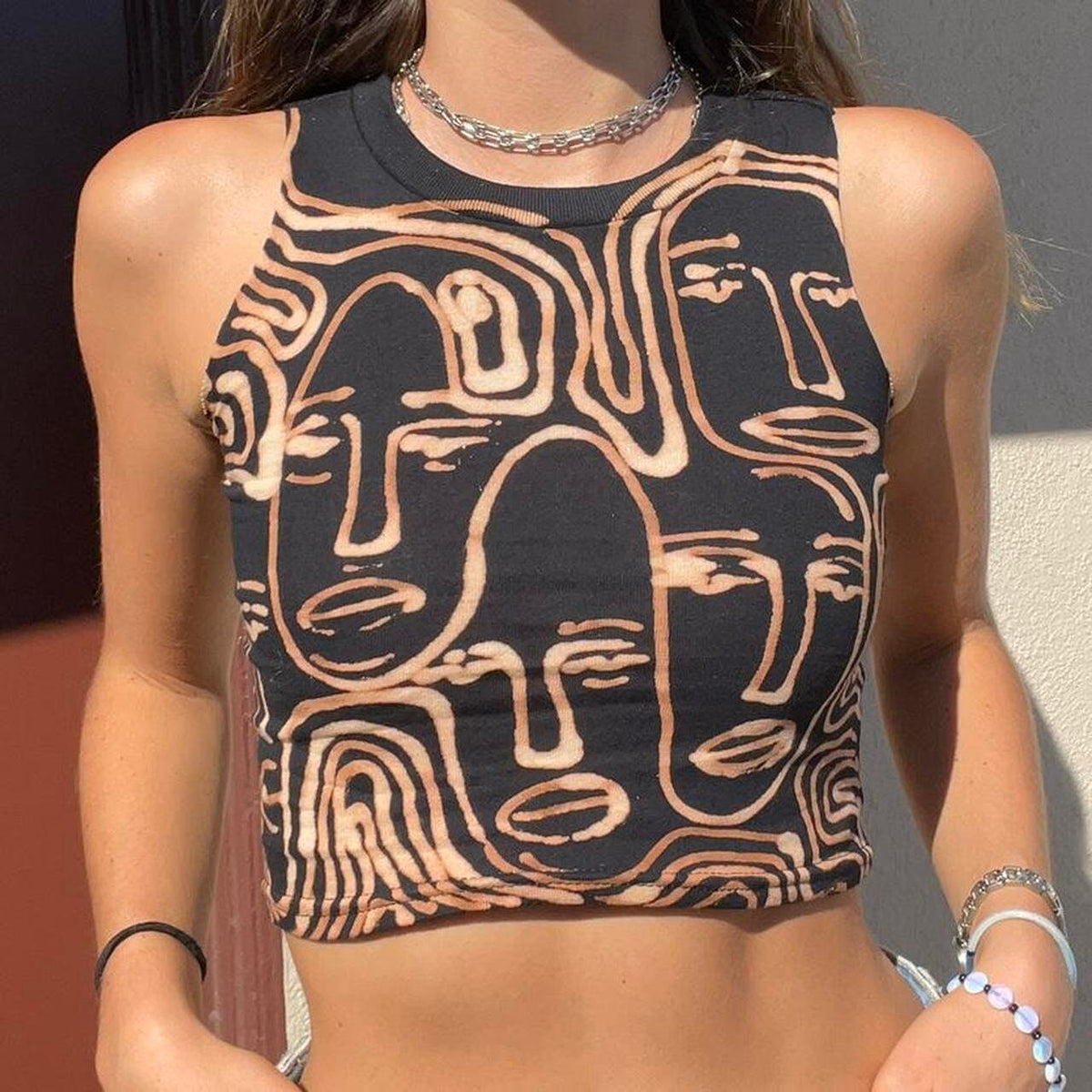Faces and geometric spiral cropped halter tank