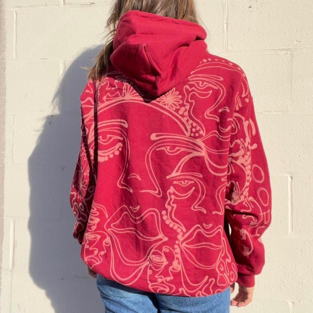 .Abstract faces, floral pattern, and geometric style hoodie in burgandy and cream