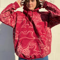 .Abstract faces, floral pattern, and geometric style hoodie in burgandy and cream